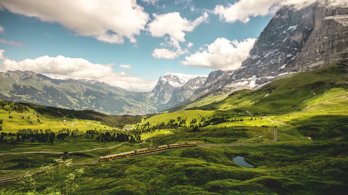 Wengen train at Kleine Scheidegg with view to Grindelwald Eiger north face